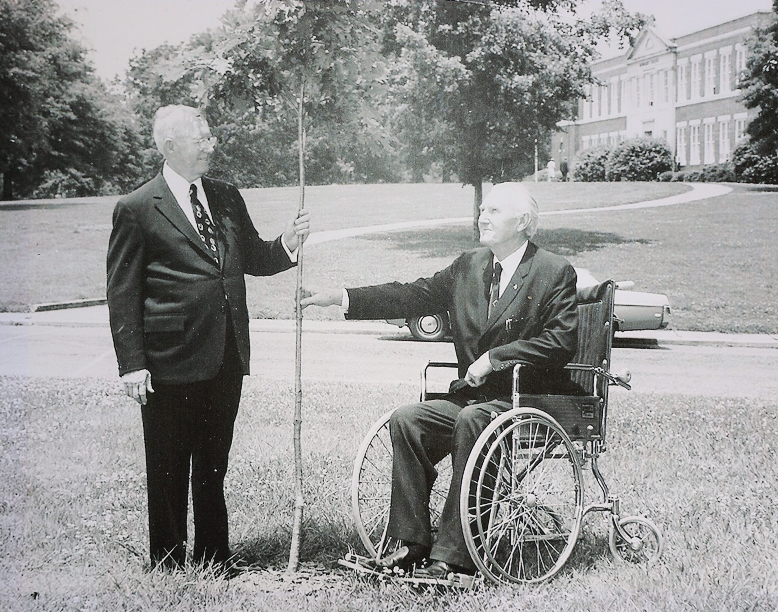 President Burgess (left) with one of the many trees he planted