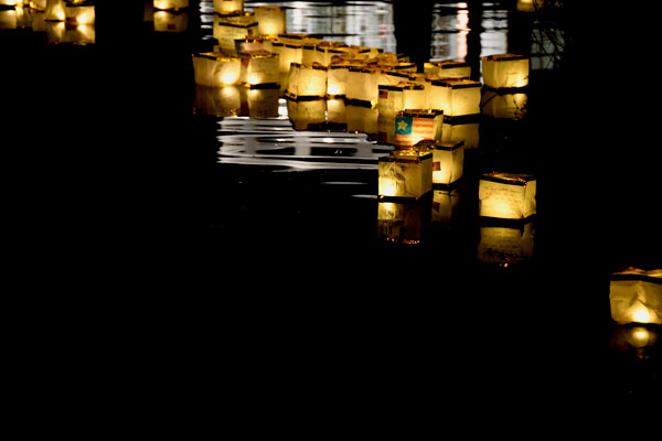 Decorated lanterns floating on the lake at night.