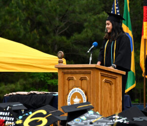 Angel Cornista addresses students at commencement.